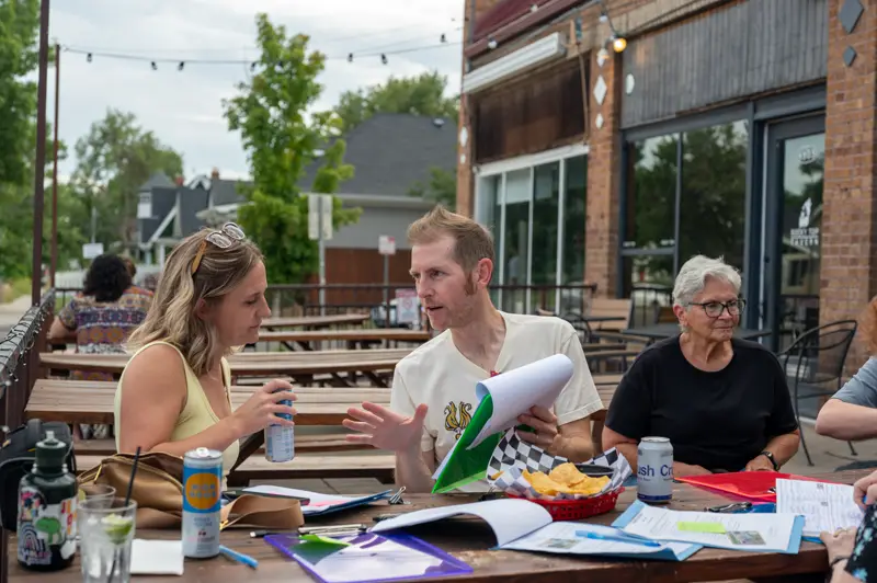 Signing night at a picnic table, papers and markers out